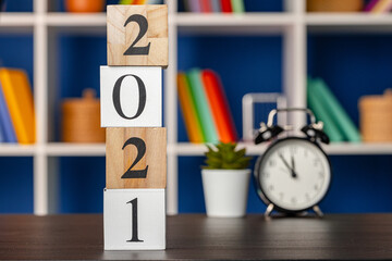 Wooden cubes with year 2021 on working table