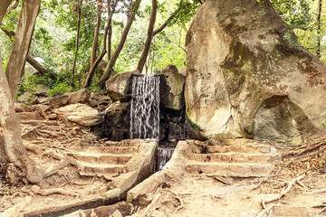 Small waterfall in the Park. Summer