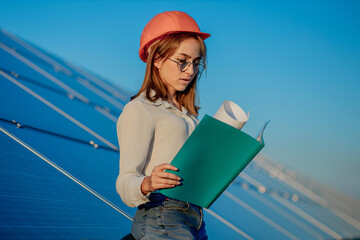 Businesswomen working on checking equipment at solar power plant with tablet checklist, woman...