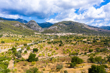 Fototapeta na wymiar Aerial view, the village of Caimari municipality of Selva on the edge of the Tramuntana mountains with agriculture, center of the island, Mallorca, Balearic Islands, Spain