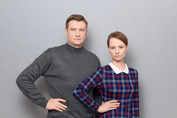 Portrait of serious man and woman standing next to each other