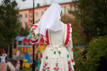 Girls in folk Russian dresses. Introduction of the folklore group on the stage. 