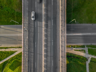 Obraz premium Bridge with cars over the road, drone view from top to bottom. City infrastructure.