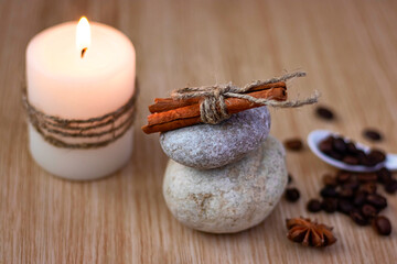 stones with cinnamon a candle coffee beans an asterisk star anise Spa setting concept Soft focus