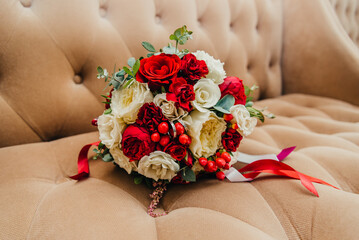 white gold wedding rings in a box and a bridal bouquet of delicate roses and greenery
