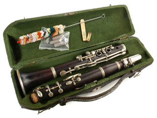 Old clarinet in a case with brush isolated on white Background