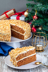 Piece of Carrot cake with cream cheese frosting and walnuts, Christmas decoration on a background, vertical