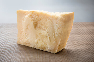 Italian aged cheese on wooden background