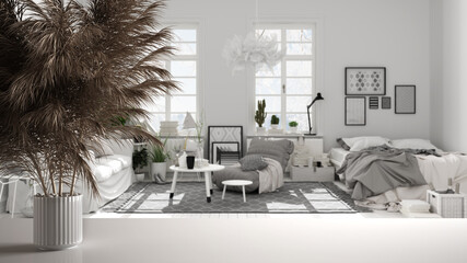 White table top or shelf with straws, dry plants, ornament, ears, sheaf, branch in vase, over black and white living room with bedroom, carpet, tables, modern minimal interior design