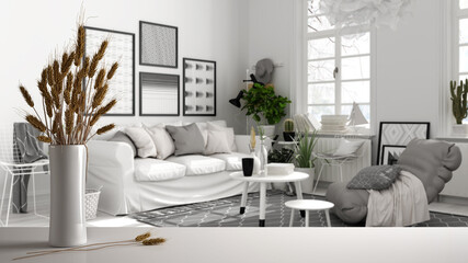White table top or shelf with straws, dry plants, ornament, ears, sheaf, branch in vase, over scandinavian living room, sofa, carpet and coffee table, modern minimal interior design