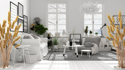 Potted straws with pebbles, dry plants, ornament, ears, sheaf, branch in vase over black and white scandinavian living room with sofa and armchair, modern minimal interior design
