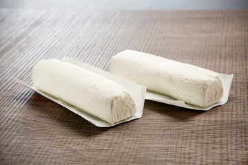 fresh italian white cheese on wooden background
