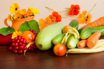 Autumn colorfull  сomposition with raw vegetables cucumbers, zucchini, tomatoes, yellow green beans, carrots. Harvest from the garden.