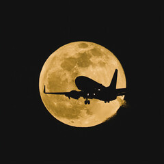 Silhouetted commercial airliner flying over the full moon