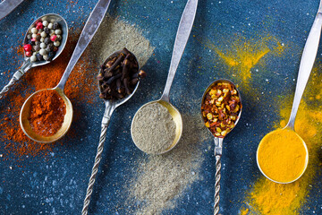variation of spices on the vintage silver spoons, all spices on the table