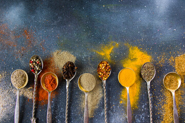 variation of spices on the vintage silver spoons, all spices on the table