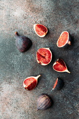 Top view of fresh ripe cutted figs on the textured background.