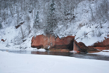 River in the winter near rocky cliff