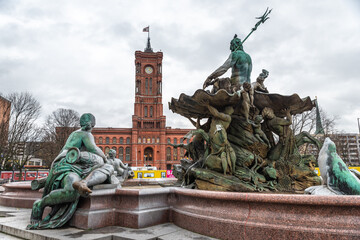 Neptune Fountain with the Red City Hall of Berlin in the background on a winter day
