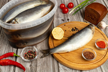 Carcass of hake silvery on a table near a knife