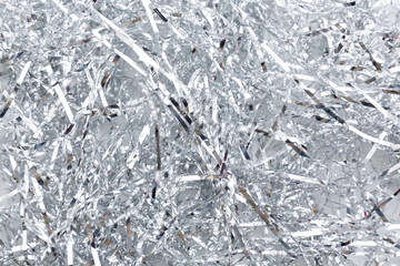 Christmas, New Year background and texture. Silver tinsel or shiny ribbons.