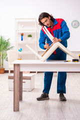 Young male carpenter working indoors