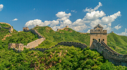 Fototapeta na wymiar Panorama photo of Great Wall in China winding over the mountains with beautiful sky above