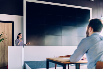 Motivational speaker presenting plan in conference hall