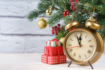 Fototapeta na wymiar Decorated Christmas tree and vintage bronze clock countdown to the new year. White background, copy space