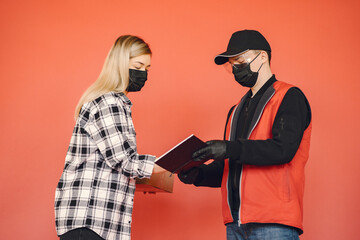 Food delivery during corona virus outbreak. Courier in a face mask. Delivering grocery order in coronavirus epidemic.
