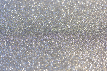 Silver abstract defocused bokeh background. Sparkling texture