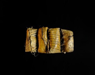 Chipilin tamales on black background. typical food of Guatemala