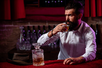 Luxury nightlife, rich bearded man drink expensive beverage.