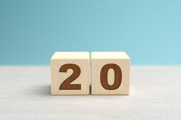 Wooden toy blocks forming the number 20.
