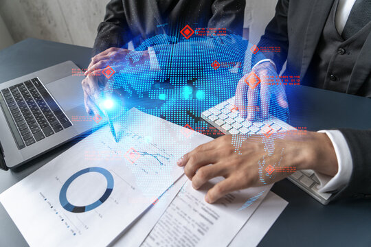 Man and woman working together on international business project. Blue infographic hologram of planet earth. World map. Multiexposure.