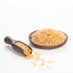 Brown rice on wooden plate and spoon , isolated on white backround.