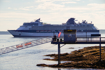 Modern luxury cruiseship or cruise ship liner anchoring on blue sea in bay offshore of Bar Harbor,...