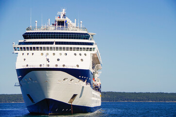 Modern luxury cruiseship or cruise ship liner anchoring on blue sea in bay offshore of Bar Harbor,...