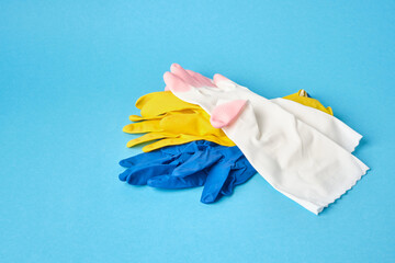 colorful of rubber gloves on blue background copy space