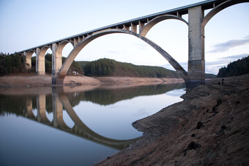 Driest season in Europe. Lake without water. The low surface on the river. The bridge above the river