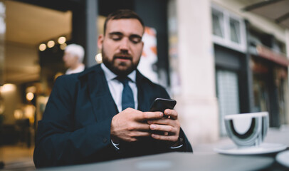 Blurred businessman using cellphone application for making online booking and banking,corporate...