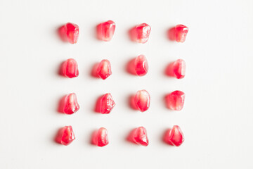 pomegranates square group of seeds isolated on white background