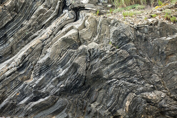 sharp rock layers at the coast of liguria in cinque terre north italy. Stone Texture background wallpaper