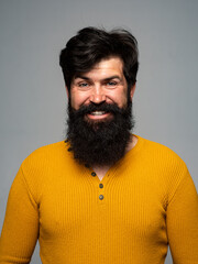 Bearded man with long beard and moustache in barbershop. Happy male smile face.
