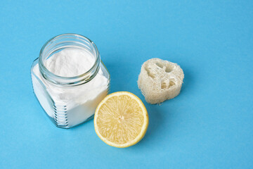 lemon, loofah and a can of soda on a blue background