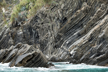 sharp rock layers at the coast of liguria in cinque terre north italy. Stone Texture background wallpaper
