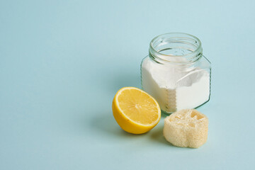 lemon, loofah and a can of soda on a light blue background