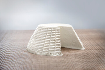 ricotta white fresh Italian cheese on wood background