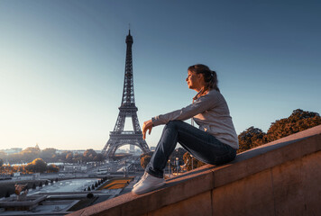 woman and Eiffel tower in sunrise time, Paris, France