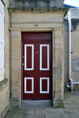 Old Brown Painted Wooden Door in Weathered Stone Surround 
